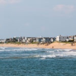 Homes line the Virginia Beach shore near the boardwalk and Rudee Inlet.