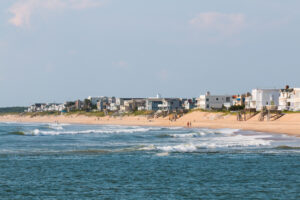 Homes line the Virginia Beach shore near the boardwalk and Rudee Inlet.